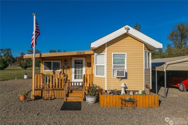 view of front of home featuring cooling unit and a carport