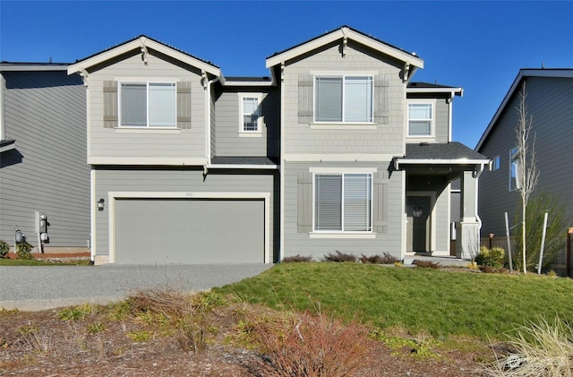 view of front facade featuring a garage and a front lawn