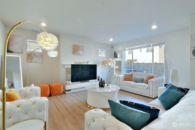 living room featuring an inviting chandelier and light wood-type flooring