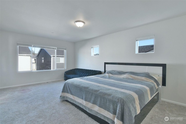 carpeted bedroom featuring multiple windows