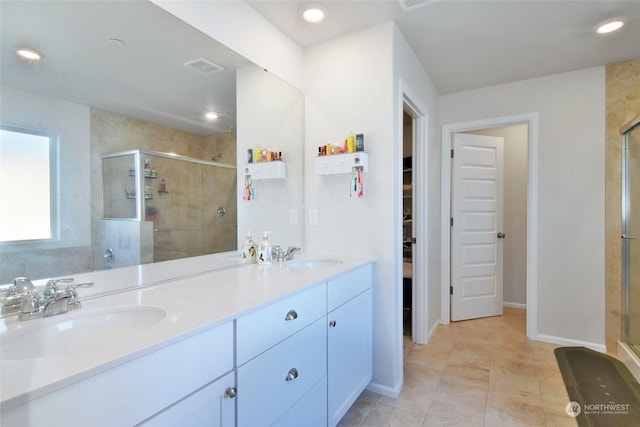 bathroom featuring vanity and a shower with shower door