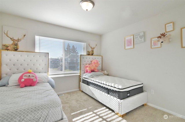 bedroom featuring multiple windows and light carpet