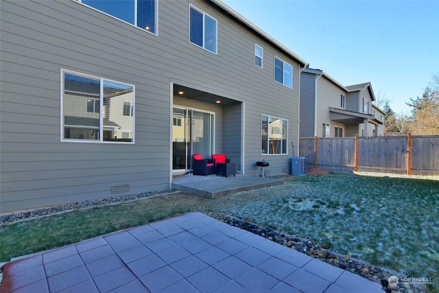 rear view of house featuring a yard and a patio