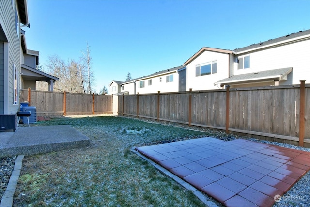 view of yard featuring a patio and central air condition unit