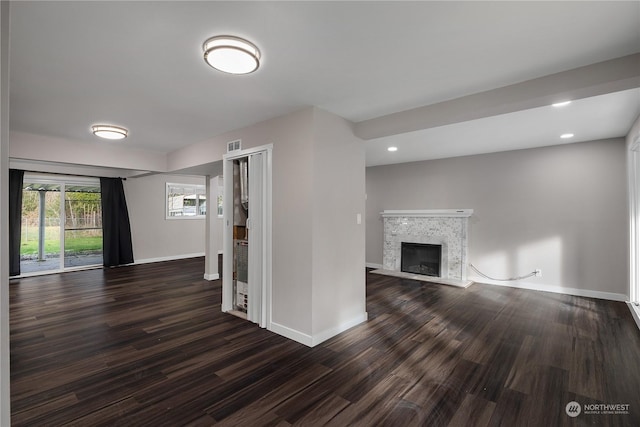 unfurnished living room featuring dark hardwood / wood-style flooring