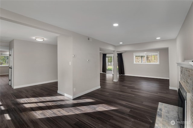 unfurnished living room with dark hardwood / wood-style flooring