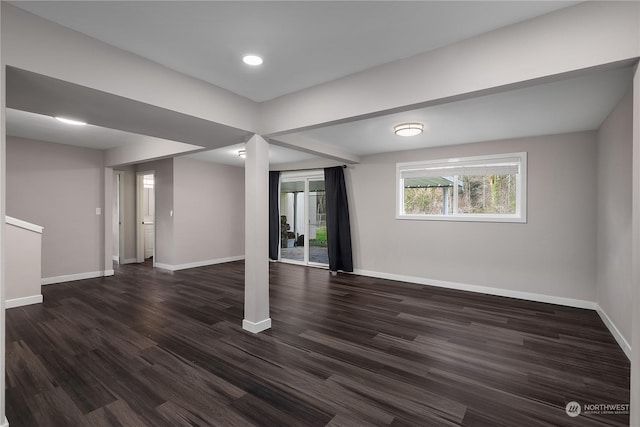 basement with dark hardwood / wood-style flooring