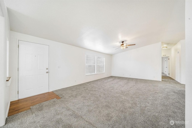 unfurnished living room featuring carpet floors and ceiling fan