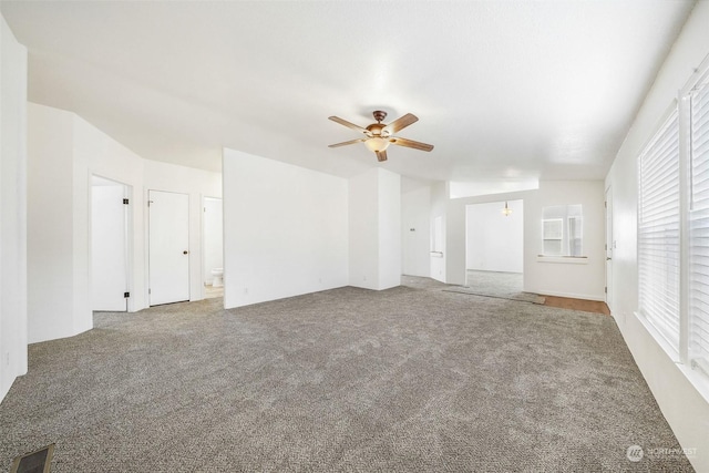 carpeted spare room with ceiling fan