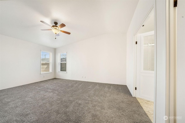 carpeted spare room with ceiling fan