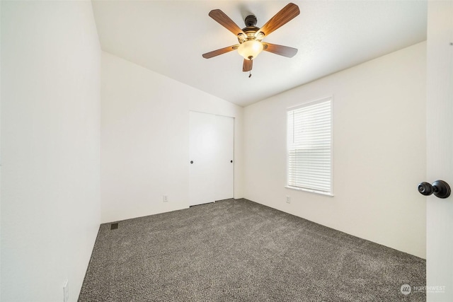 carpeted spare room with lofted ceiling and ceiling fan