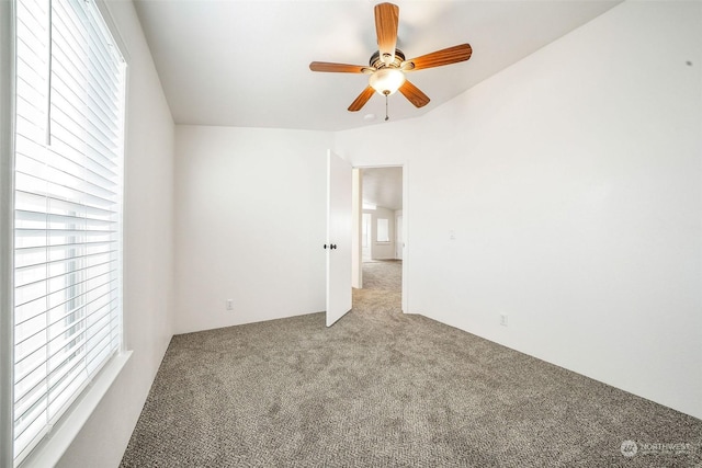 carpeted empty room featuring ceiling fan