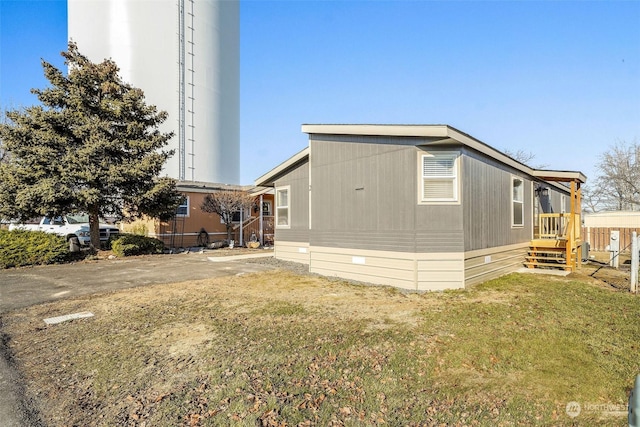 view of property exterior featuring a lawn