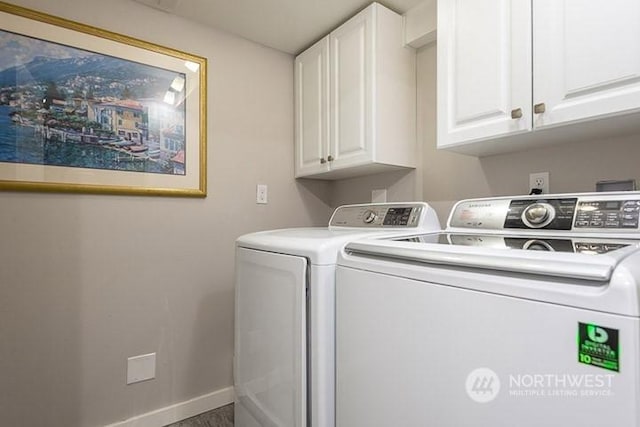 clothes washing area with cabinet space, baseboards, and separate washer and dryer