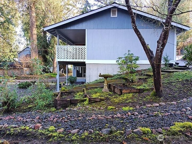 view of property exterior featuring a garden