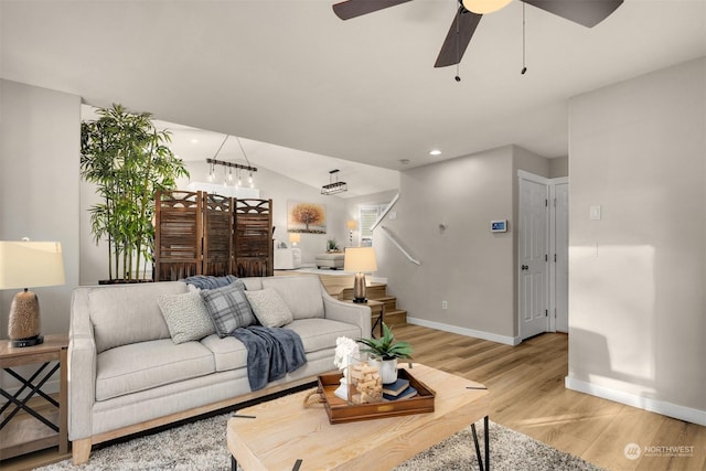 living room featuring ceiling fan and light hardwood / wood-style floors