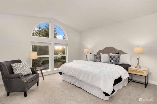 bedroom with vaulted ceiling and light colored carpet