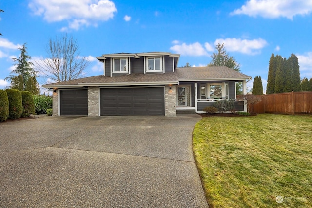 view of front of property featuring a garage, a front lawn, and a porch