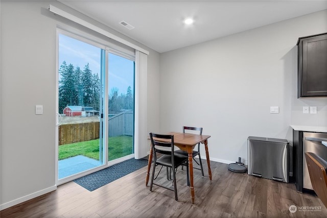 dining area with dark wood-type flooring and plenty of natural light