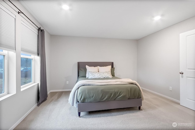 bedroom featuring light colored carpet