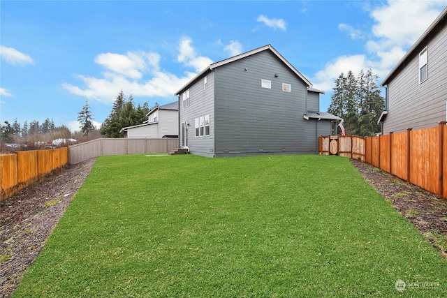 back of house with a lawn