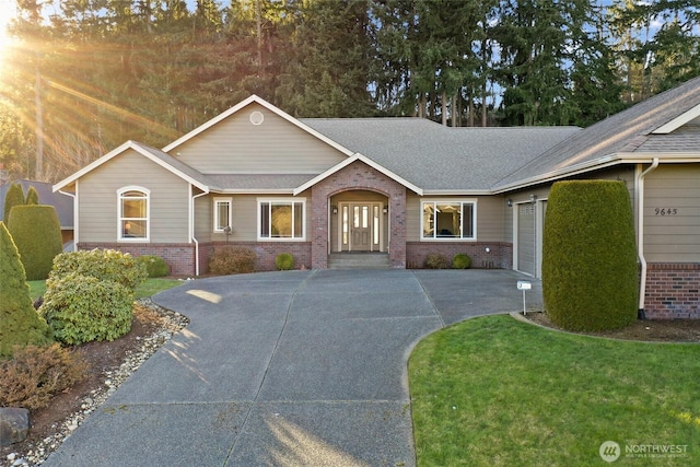 ranch-style house featuring a garage and a front yard