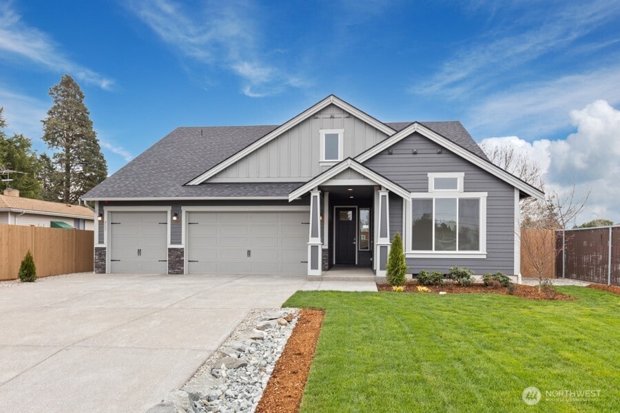14203 Jensen Dr SE Unit 362, Yelm, WA 98597 - craftsman inspired home featuring a garage, fence, a front yard, and board and batten siding