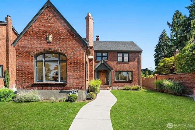 tudor home featuring a front yard