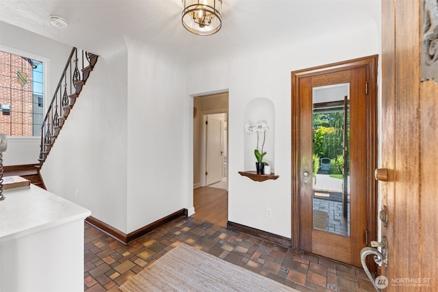 foyer with a chandelier