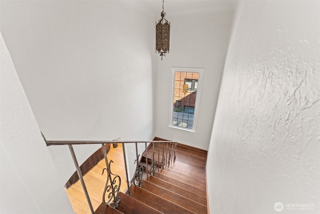 stairs featuring hardwood / wood-style flooring