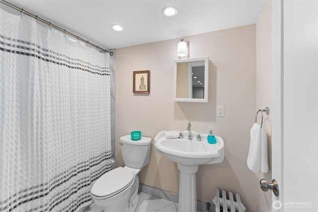 bathroom featuring a shower with curtain, radiator, and toilet