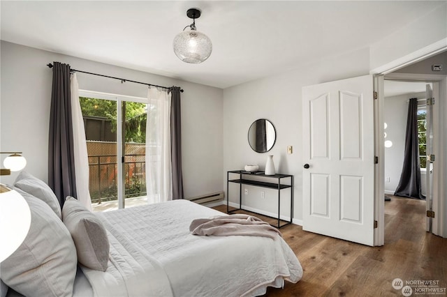 bedroom with hardwood / wood-style flooring, a baseboard radiator, and access to outside