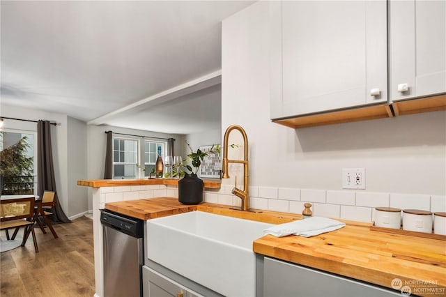 kitchen with plenty of natural light, dishwasher, decorative backsplash, and white cabinets