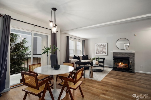 dining room with a fireplace and hardwood / wood-style floors