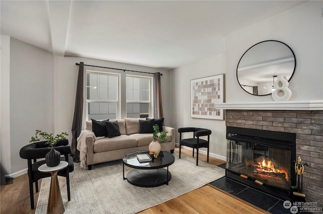 living room featuring wood-type flooring and a fireplace