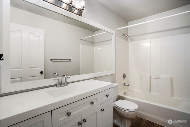 full bathroom with vanity, hardwood / wood-style flooring, toilet, and shower / bath combination