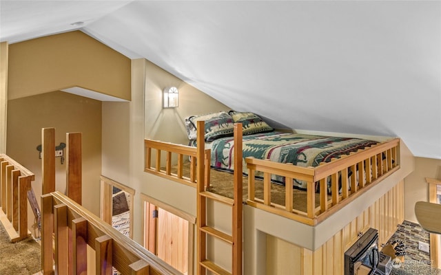 carpeted bedroom with lofted ceiling