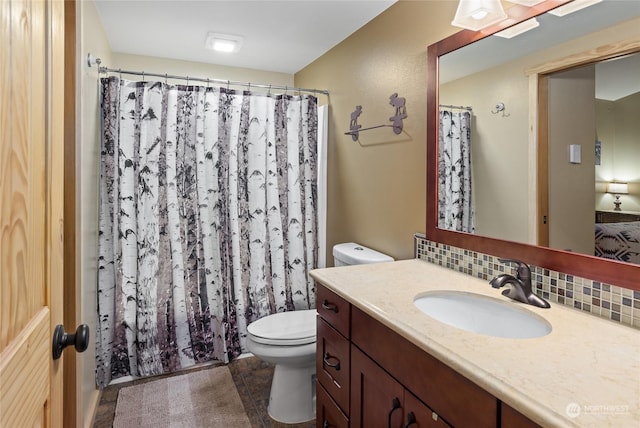 bathroom featuring vanity, decorative backsplash, toilet, and a shower with shower curtain