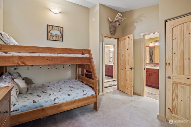 carpeted bedroom featuring connected bathroom