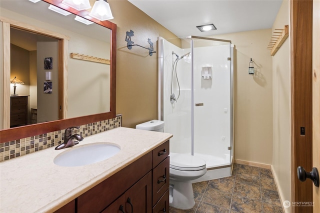 bathroom featuring tasteful backsplash, vanity, toilet, and a shower with shower door