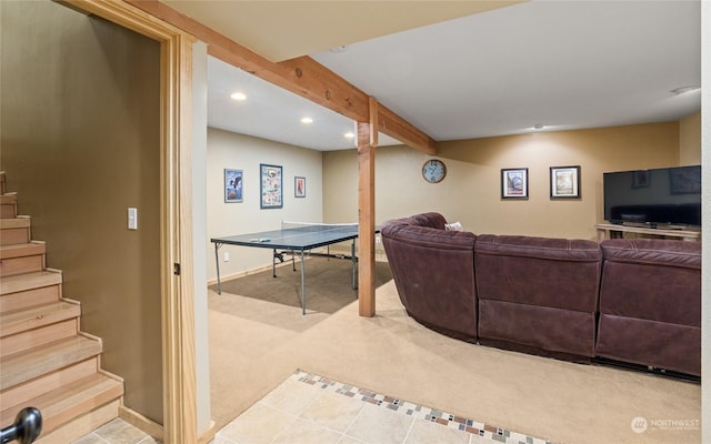 carpeted living room featuring beam ceiling