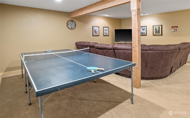 game room with light carpet and beam ceiling