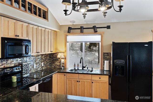 kitchen with tasteful backsplash, sink, dark stone countertops, black appliances, and an inviting chandelier