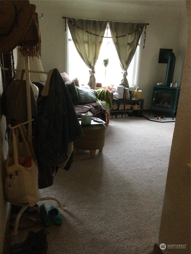 interior space featuring carpet floors and a wood stove