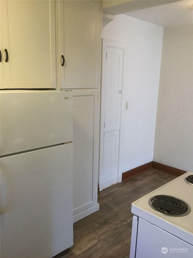 kitchen featuring white cabinetry, white appliances, and dark hardwood / wood-style floors