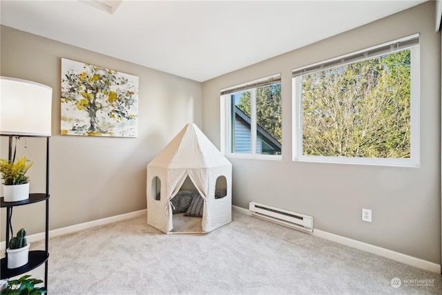 playroom with a baseboard radiator and light carpet