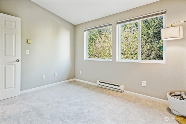 carpeted spare room featuring baseboard heating