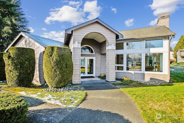 view of front of house featuring french doors and a front yard