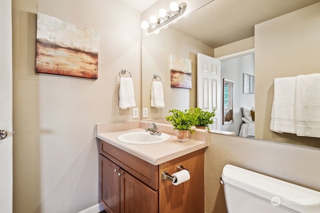 bathroom featuring vanity and toilet