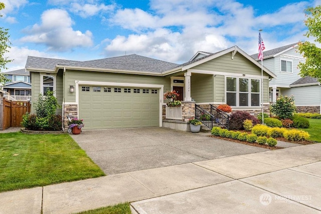 craftsman house featuring a garage and a front lawn